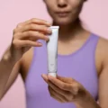 woman holding retinol