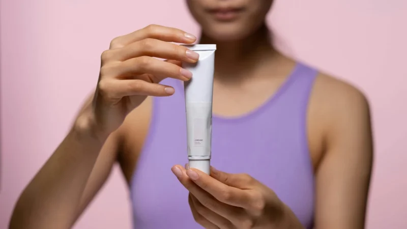 woman holding retinol
