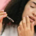 woman applying hyaluronic acid on her face