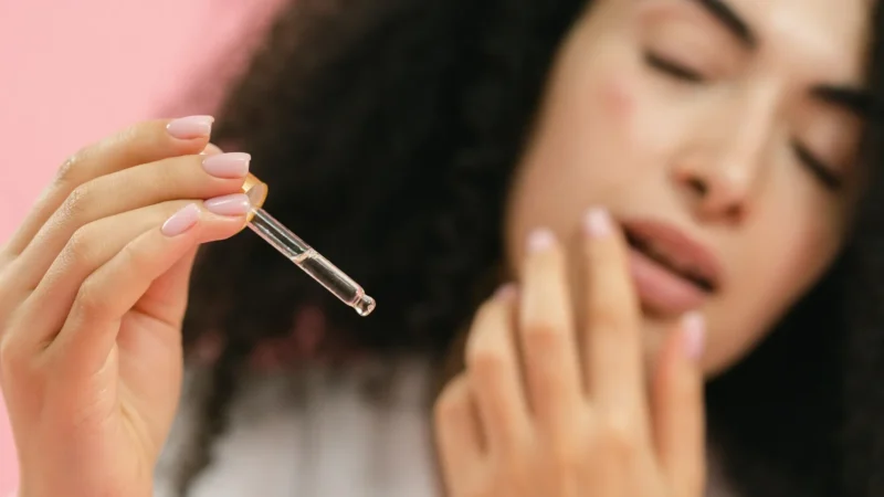 woman applying hyaluronic acid on her face